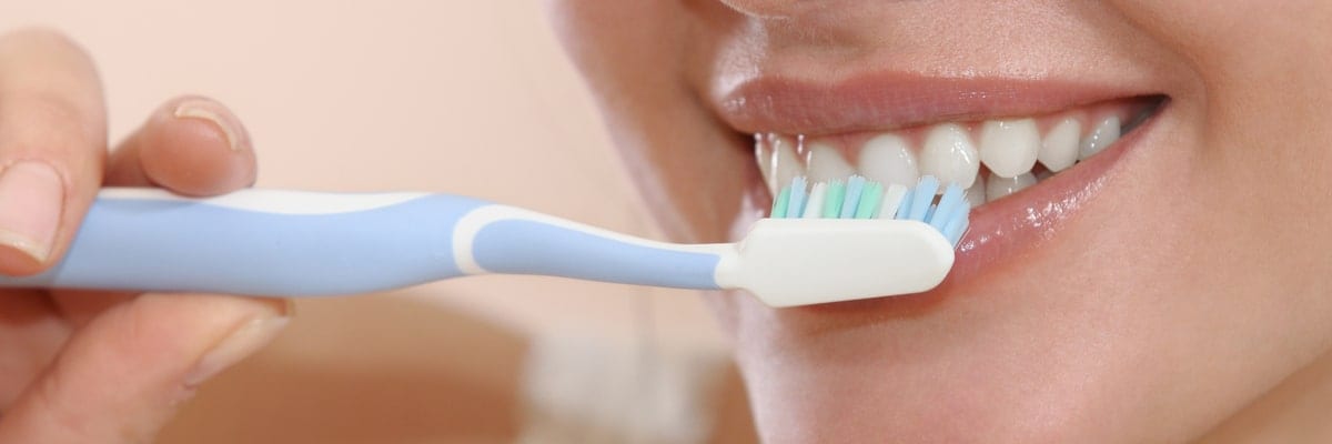 Woman brushing teeth