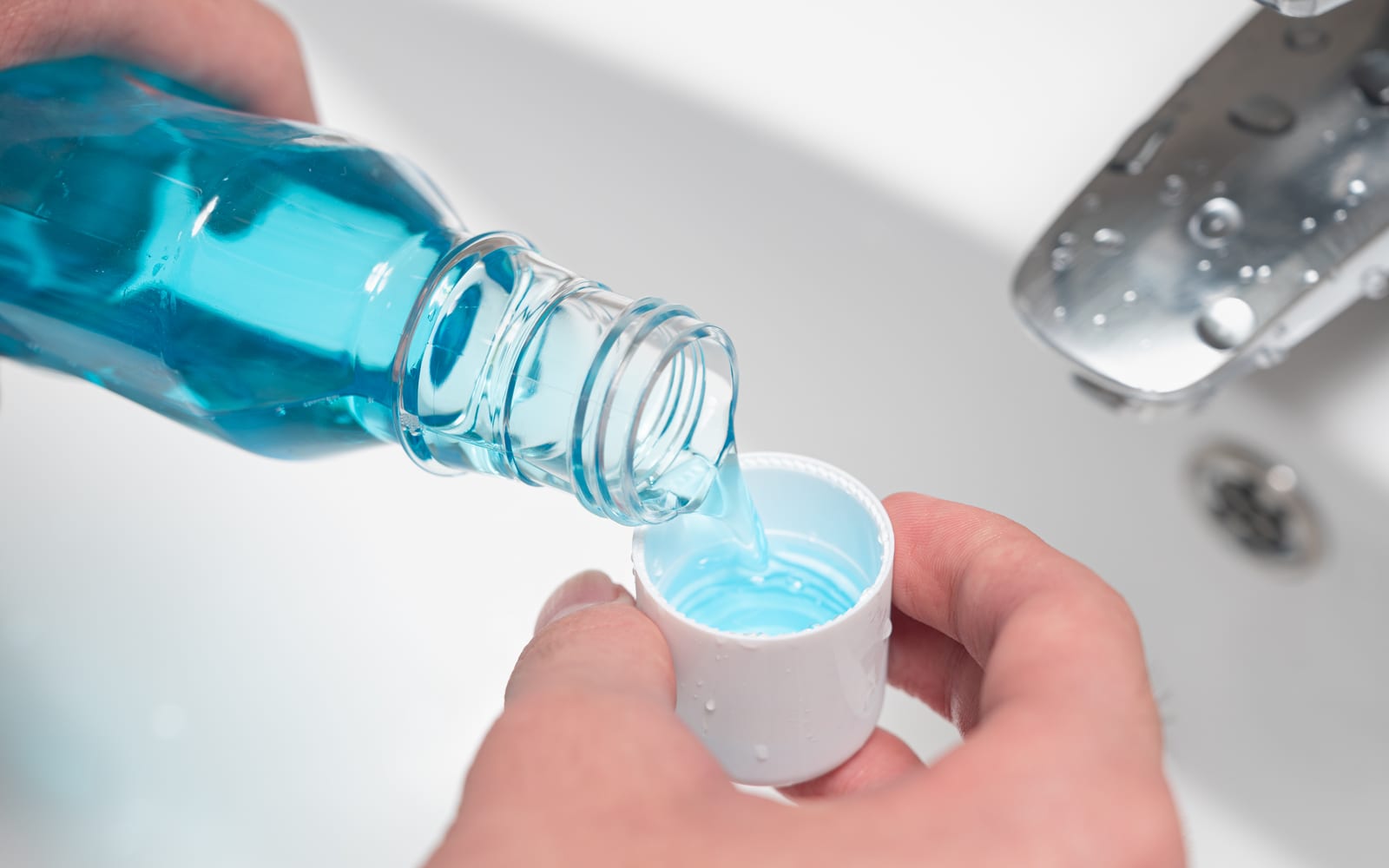 Fluoride containing mouthwash being used